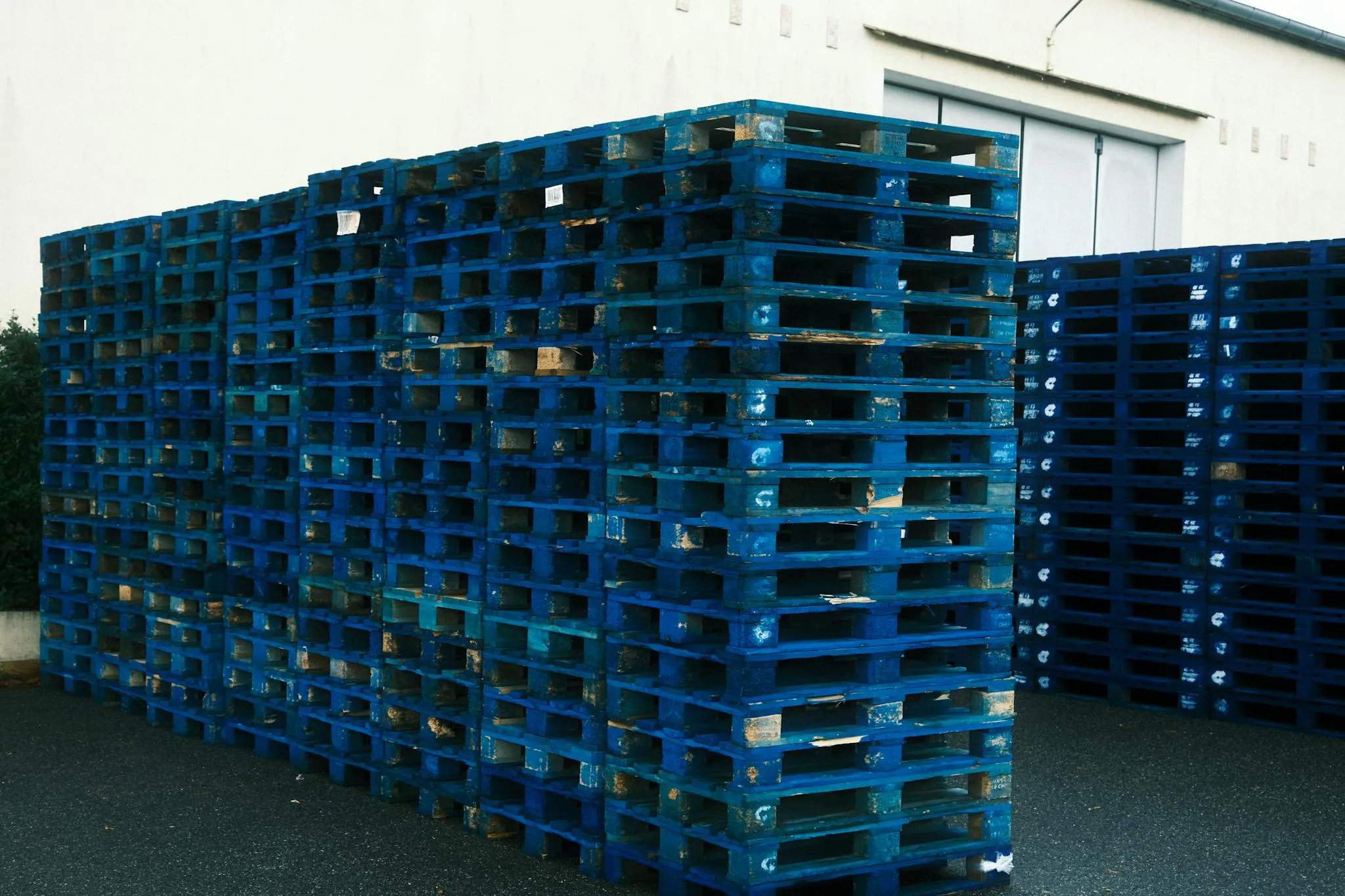 Stacks of pallets representing logistics resources and storage capacity.